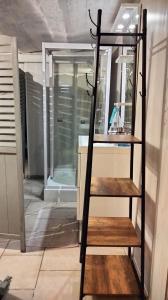 a shelf in front of a bathroom with a mirror at Appartement dans le Morvan 16 min de l'autoroute in Beauvilliers