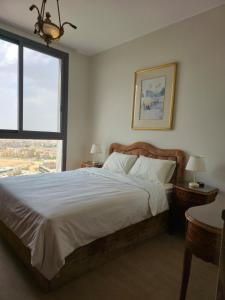 a bedroom with a large bed and a window at The view in Banī Ghālib