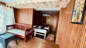 a small room with a bed and a table at Alivious Beach Homestay in Alleppey