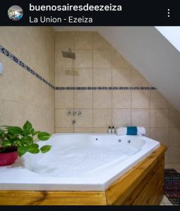 a large white tub in a bathroom with at Buenos Aires de Ezeiza Duplex- Piscinas- Playroom- Sauna in La Unión