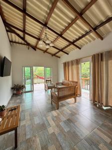 a large living room with benches and a table at KETHALYA TAYRONA Hostal in El Zaino +94 photos
