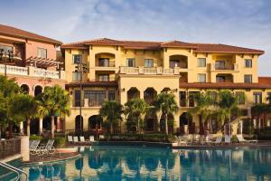 a hotel with a swimming pool in front of a building at Club Wyndham Bonnet Creek in Orlando