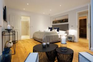 a bedroom with a bed and two tables with candles at Villa Hengist mit eigener Sauna, 600 Meter vom Weststrand, Wenningstedt, Sylt in Wenningstedt