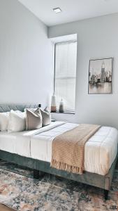 a white bedroom with a large bed with a window at Downtown 2BR, Full Kitchen, PPAC&Convention Center in Providence +29 photos