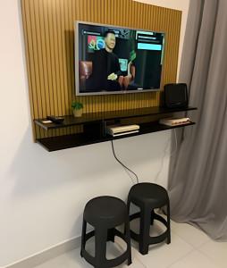 圣保罗1702 Expo Transamérica - Vista para Represa - Varanda的客厅配有2张凳子和1台电视 更多18张照片