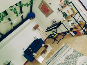 an overhead view of a living room with a piano at Petit cocon vue mer in Gourbeyre +9 photos