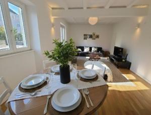 a living room with a table with plates on it at Stubel-Riedisheim in Riedisheim