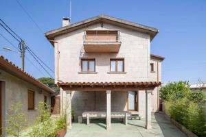 a building with a bench in front of it at Casa con vistas al mar, playa 300 m, parking, wifi in Ribeira