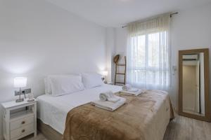 a bedroom with a bed with two towels on it at Gaia - Villas de Bolonia in Aduanas +28 photos