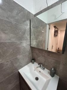 a bathroom with a sink and a mirror at Apartmani Zeko Uskoplje Centar in Gornji Vakuf +20 photos