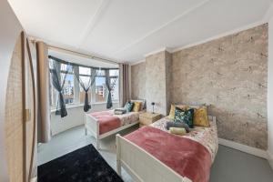 a bedroom with two beds and a window at Lesley House 4 bed villa TV Internet Garden in Gillingham