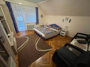 a small room with a bed and a carpet at Balaton-Lak Apartmanház in Siófok +9 photos