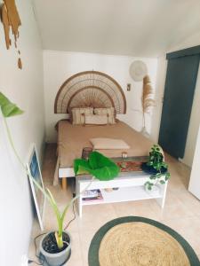 a small bedroom with a bed and a table at Petit cocon vue mer in Gourbeyre