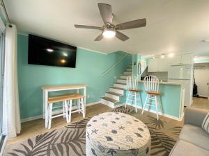 a living room with a couch and a ceiling fan at 423 Sea Cloud in Edisto Island
