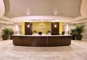 a large lobby with a reception desk in a building at Club Wyndham Ocean Boulevard in Myrtle Beach