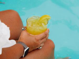 eine Frau hält ein Getränk mit einer Zitronenscheibe in der Unterkunft Hacienda del Rio in New Braunfels + 23 Fotos
