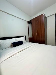 Postel nebo postele na pokoji v ubytování Queens Stay Apartment