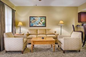 a living room with a couch and two chairs and a table at Club Wyndham Cypress Palms in Kissimmee