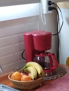 a red coffee maker with a basket of fruit on a counter at Sueño Dorado Container in Chapadmalal +7 photos