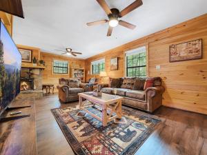 a living room with a couch and a table at The Eagle's Nest Mountain Cabin Gatlinburg in Gatlinburg