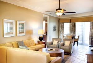 a living room with a couch and chairs and a table at Club Wyndham at Majestic Sun in Destin