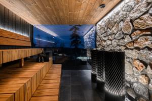 a lobby of a restaurant with a stone wall at Aura Arctic Chalets - Grand Panoramic & Grand Hideaway in Saariselka