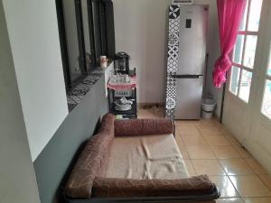 a brown couch sitting in a hallway next to a door at MC Location in Abidjan