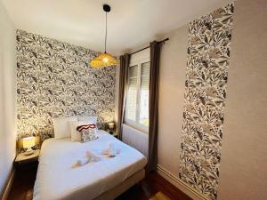 a bedroom with a bed with shoes on it at 6 benoit in Reims