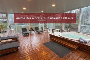 a jacuzzi tub in a building with a sign at Villa Sofía Apart Hotel & Spa in San Carlos de Bariloche