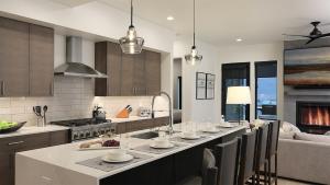 a kitchen with a long table with chairs and a couch at Principal House in Steamboat Springs