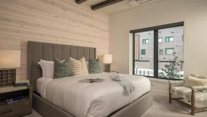 a bedroom with a large bed and a window at Principal House in Steamboat Springs
