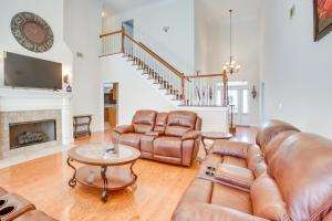 a living room with leather furniture and a fireplace at 8 Mi to University of Alabama Family Home with Yard in Englewood