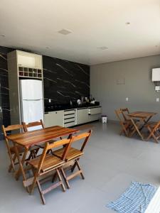 a kitchen with a wooden table and two chairs at Villa Hotel in Bom Jesus da Lapa