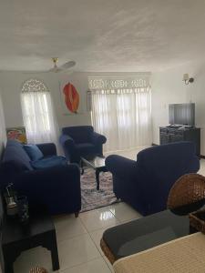 a living room with two blue couches and a table at Gem in Runaway Bay
