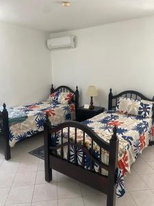 two beds sitting next to each other in a bedroom at Gem in Runaway Bay +21 photos