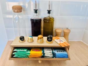 a wooden shelf with chopsticks and two bottles of oil at Appartement proche Ancenis - Loire et Vélo in Liré +8 photos