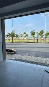 a view from a window of a street with two benches at Two-bedroom flat - River view, elevator, free inside car parking in Mỹ Phước