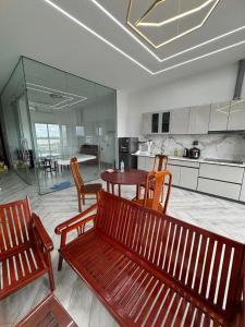 a kitchen with two wooden benches and a table at Two-bedroom flat - River view, elevator, free inside car parking in Mỹ Phước