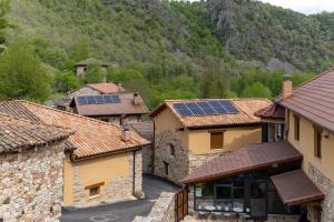 a group of buildings with solar panels on their roofs at El Refugio II de Verdiago in Verdiago
