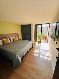 a bedroom with a bed and a large window at BIG HOUSE, máximo 22 personas !!!!!!!!!!!!!!! in Guadalajara