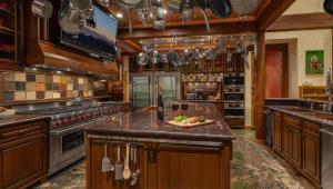 a large kitchen with wooden cabinets and a counter top at Rocking Chair Lodge in Steamboat Springs