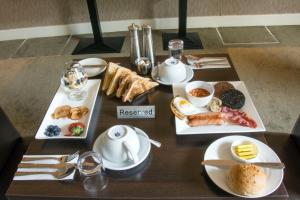 a table topped with plates of food and drinks at Helix Hotel in Grangemouth