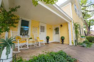 a yellow house with chairs and a table on a porch at Stunning Historic Home Lots of Space In Town in Kanab