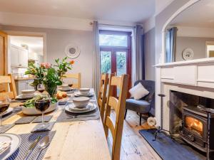 ein Esszimmer mit Tisch und Kamin in der Unterkunft 4 Bed in Bideford 85720 in Bideford
