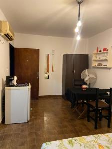 a living room with a table and a small kitchen at Olivos Stay in Olivos