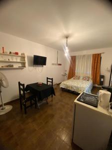 a bedroom with a bed and a table with a desk at Olivos Stay in Olivos +9 photos