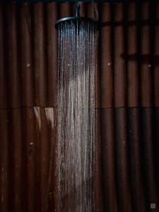 a shower with water coming out of it at SuiteXO in Ons Belang
