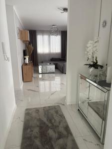 a living room with white walls and a marble floor at MY PLACE Il in Slavonski Brod
