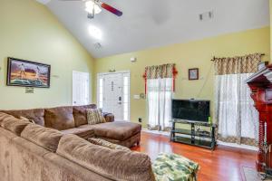 a living room with a couch and a flat screen tv at Georgia Vacation Rental 14 Mi to Downtown Augusta in Hephzibah