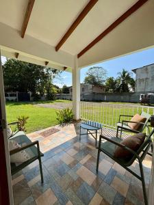 a patio with two chairs and a table on a patio at Casa del Mar Beach House Costa Rica Pacific Coast in Esterillos